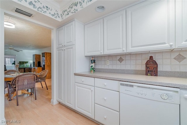 806 SE 46th St Unit 1E, Cape Coral, FL 33904 - kitchen featuring tasteful backsplash, white dishwasher, ceiling fan, light hardwood / wood-style flooring, and white cabinets