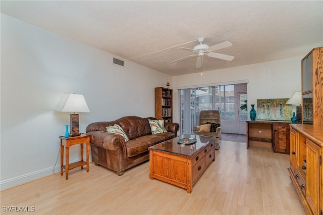 806 SE 46th St Unit 1E, Cape Coral, FL 33904 - living room with ceiling fan, light hardwood / wood-style floors, and a textured ceiling