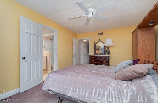 806 SE 46th St Unit 1E, Cape Coral, FL 33904 - bedroom with ceiling fan, ensuite bathroom, light colored carpet, and a textured ceiling