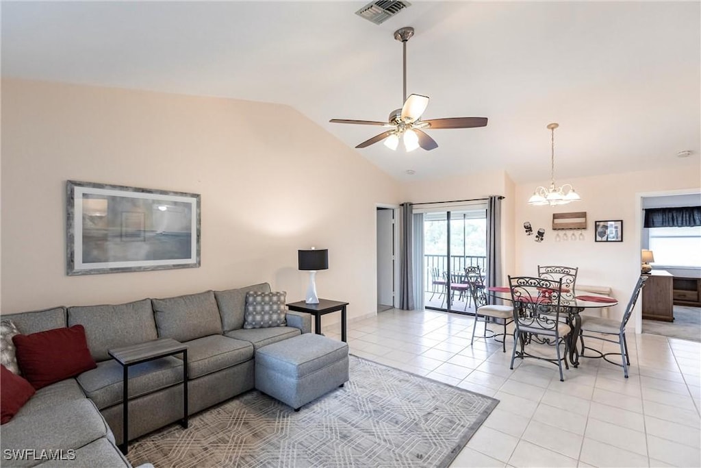 tiled living room with vaulted ceiling and ceiling fan with notable chandelier