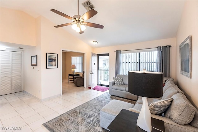 tiled living room with ceiling fan and lofted ceiling