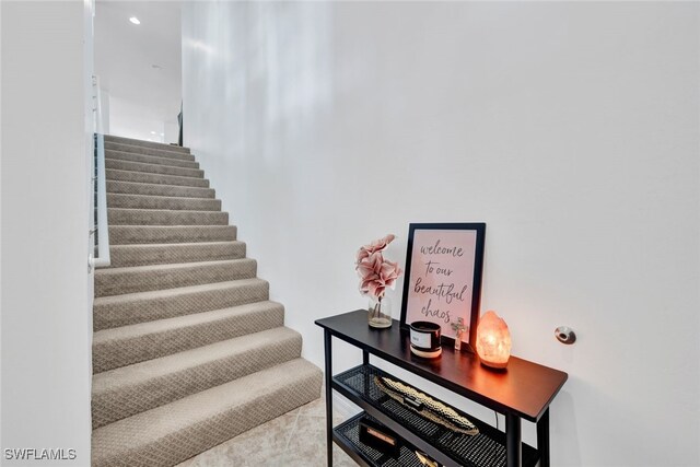 stairway featuring tile patterned floors