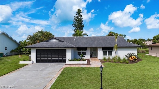 ranch-style home with a garage, driveway, a front lawn, and stucco siding