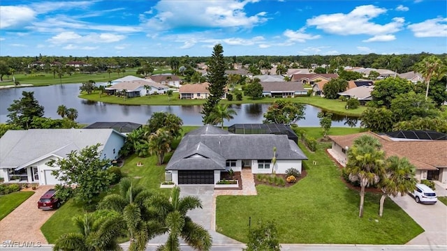 drone / aerial view with a water view and a residential view