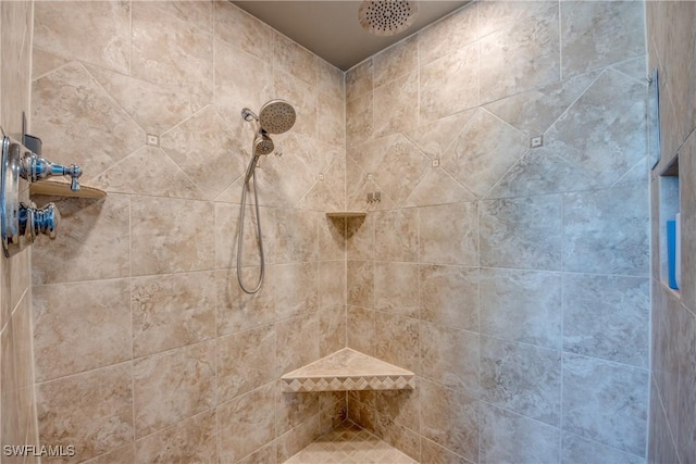 bathroom with a tile shower