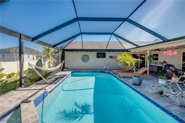 view of pool featuring a lanai, a patio area, and ceiling fan