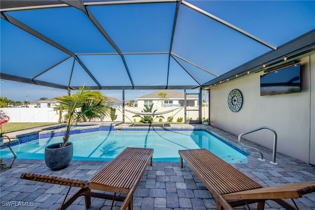 view of swimming pool with a lanai and a patio area