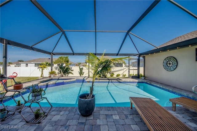 view of swimming pool featuring an in ground hot tub, glass enclosure, and a patio area