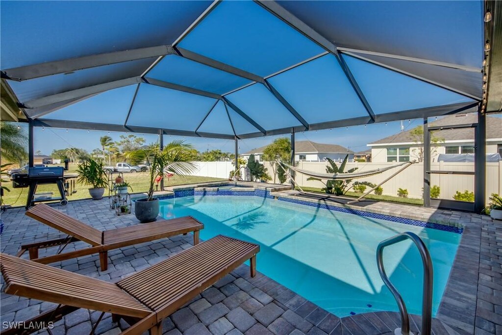 2535 NW 6th Ter, Cape Coral, FL 33993 - view of swimming pool featuring a patio area, glass enclosure, and grilling area