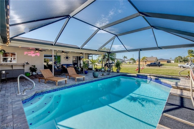 view of pool with a patio area and a lanai