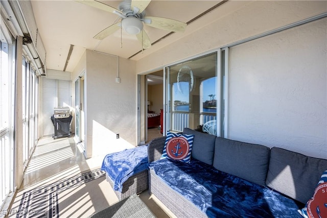 sunroom / solarium featuring ceiling fan