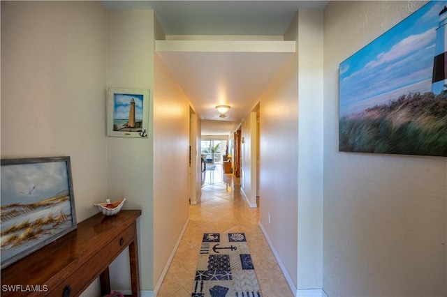 hall featuring light tile patterned flooring