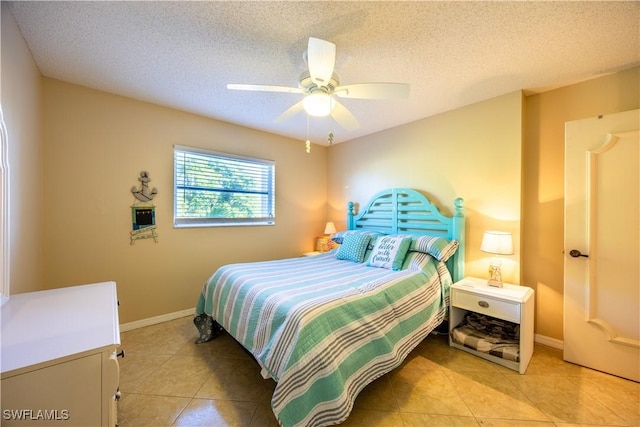 tiled bedroom with ceiling fan and a textured ceiling