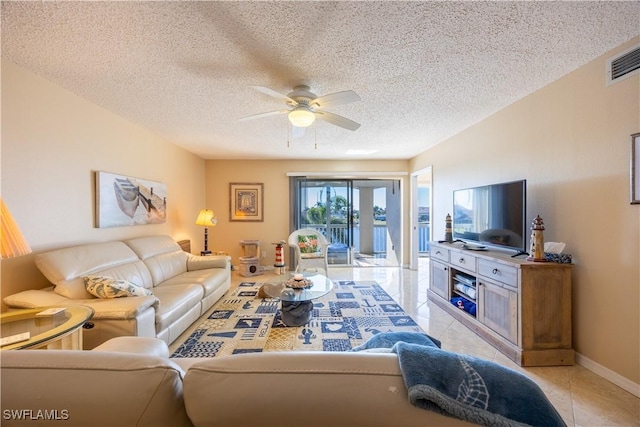 tiled living room featuring ceiling fan and a textured ceiling