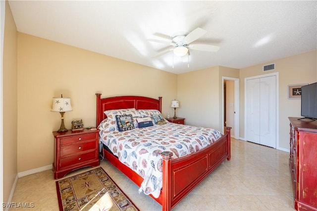 tiled bedroom with ceiling fan and a closet