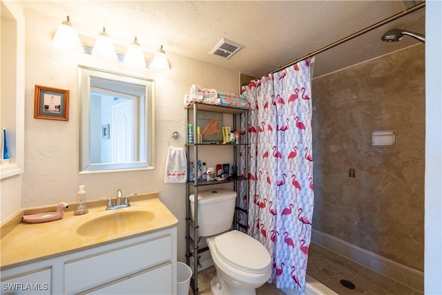 bathroom with vanity, toilet, and curtained shower