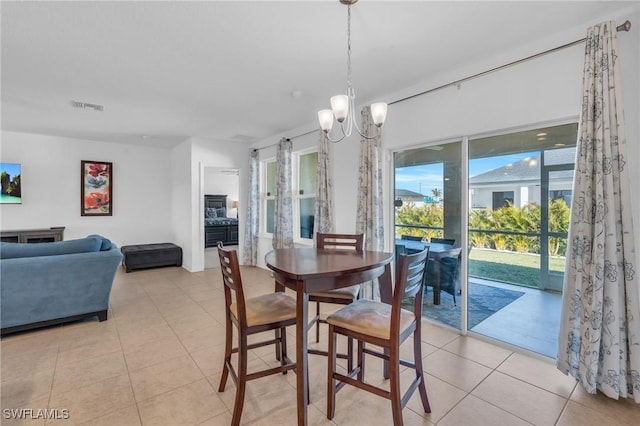 tiled dining space featuring a notable chandelier