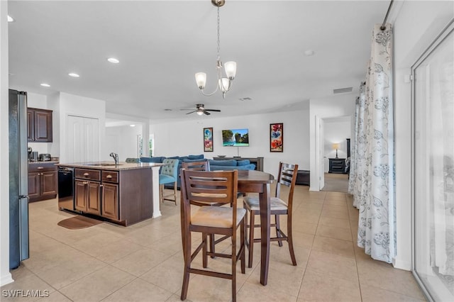 tiled dining space with ceiling fan with notable chandelier and sink