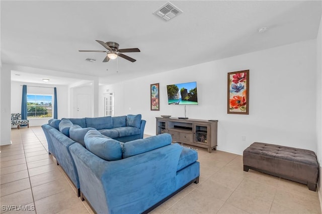 living room with ceiling fan and light tile patterned flooring