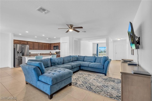 tiled living room featuring ceiling fan