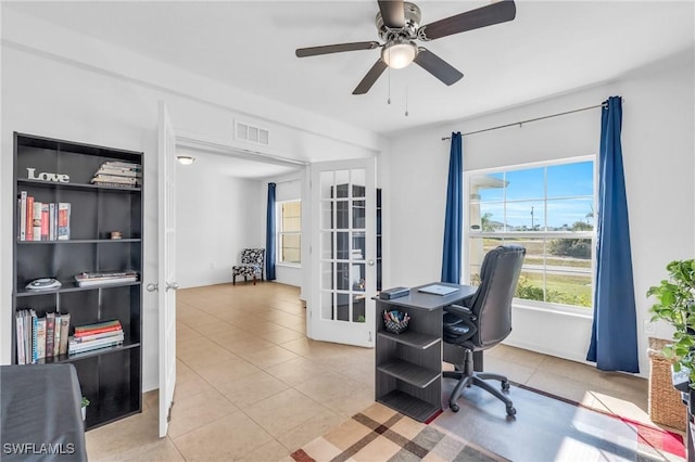 office featuring french doors, ceiling fan, and light tile patterned flooring