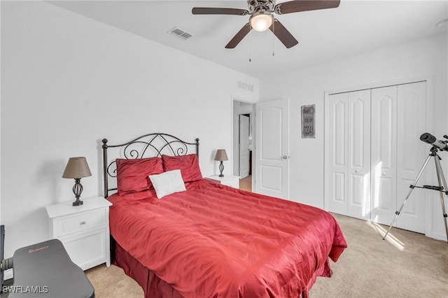 carpeted bedroom with ceiling fan and a closet