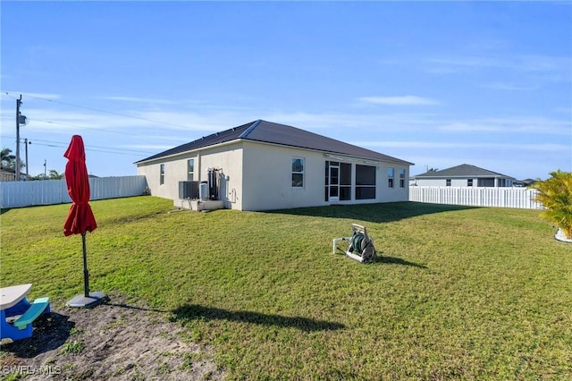 rear view of property featuring a yard