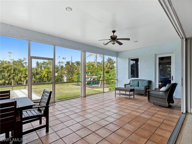 sunroom / solarium featuring ceiling fan and a healthy amount of sunlight