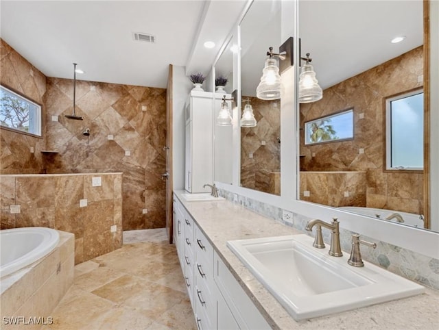 bathroom with vanity, tile walls, a wealth of natural light, and shower with separate bathtub