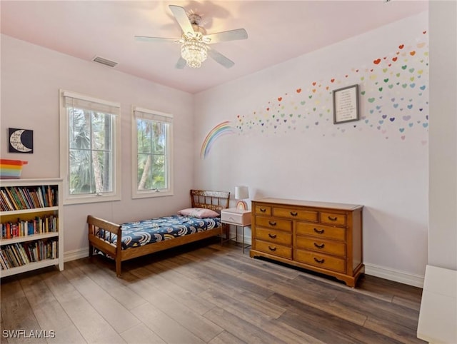 bedroom with ceiling fan and dark wood-type flooring