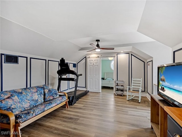 interior space with ceiling fan, lofted ceiling, and light hardwood / wood-style flooring