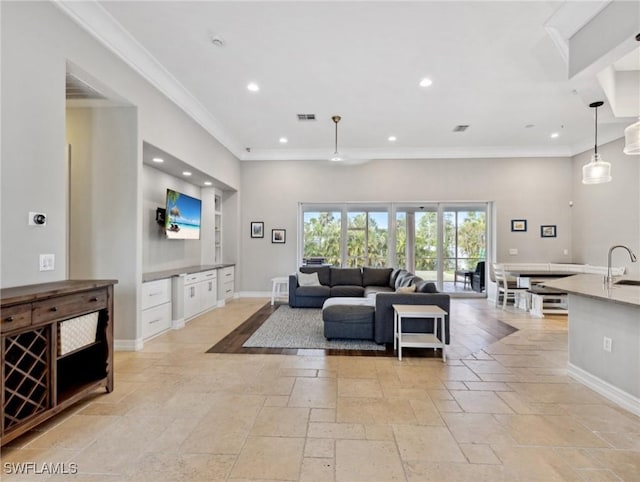 living room with sink and ornamental molding