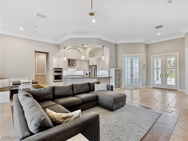 living room featuring ornamental molding and french doors