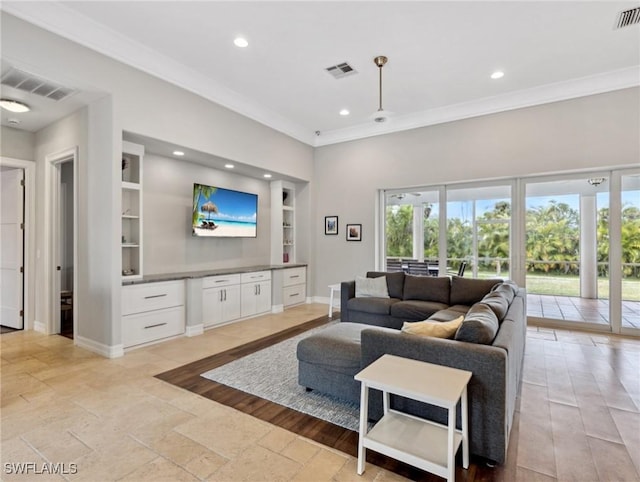 living room with ceiling fan, ornamental molding, built in features, and plenty of natural light