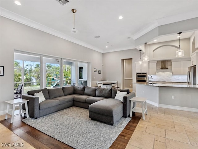 living room with sink and ornamental molding