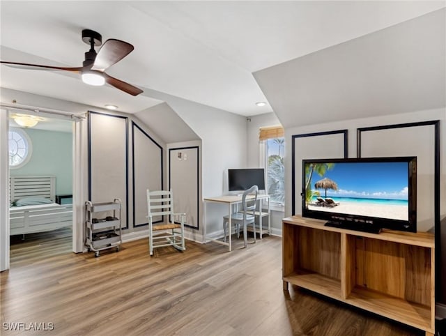 interior space with ceiling fan, hardwood / wood-style floors, and lofted ceiling