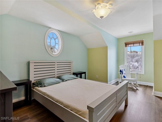 bedroom featuring dark hardwood / wood-style flooring and vaulted ceiling