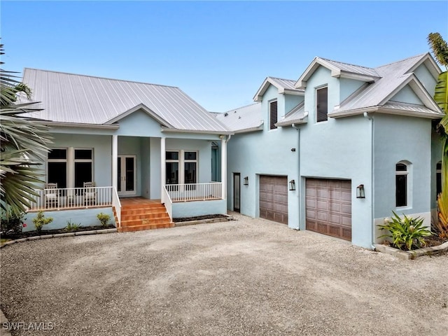 view of front facade with a porch and a garage