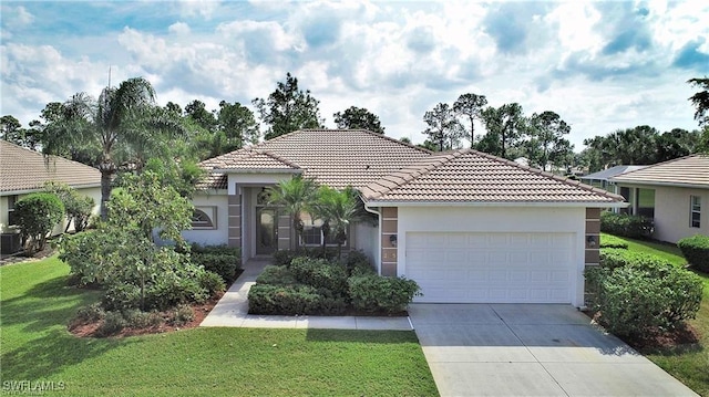 view of front of property with central AC, a garage, and a front lawn