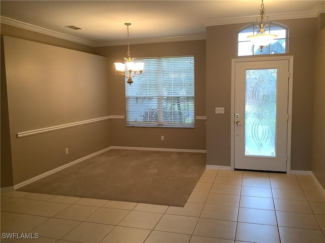 entryway featuring a notable chandelier, light tile patterned floors, ornamental molding, and a wealth of natural light