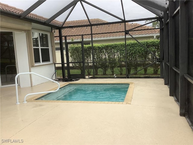 view of pool with a patio and a lanai