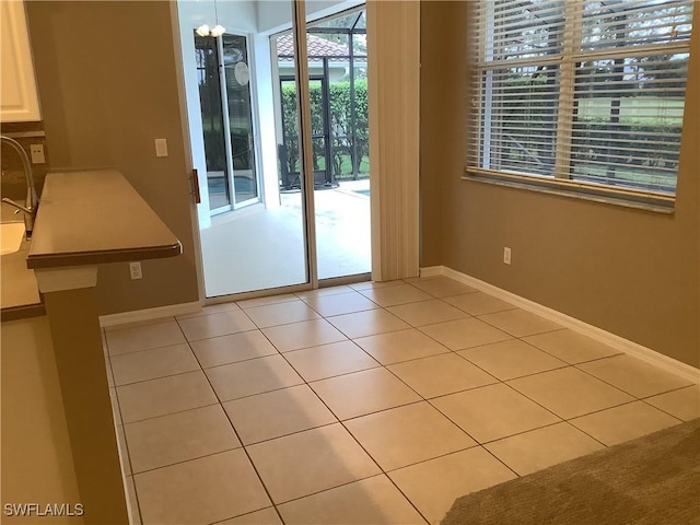 doorway with light tile patterned floors