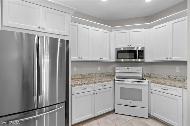 kitchen featuring light stone countertops, white cabinetry, and stainless steel appliances