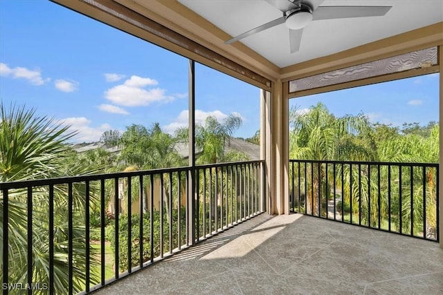 unfurnished sunroom with ceiling fan