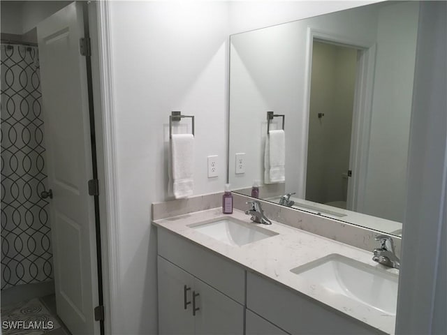 full bathroom featuring double vanity, a sink, and a shower with curtain