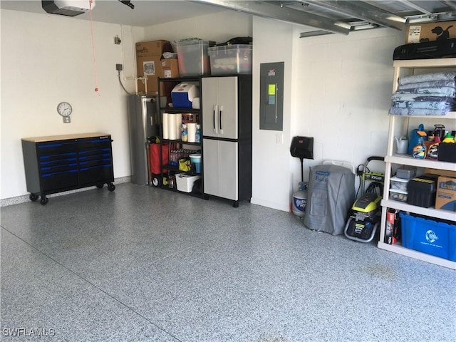 garage featuring a garage door opener, electric panel, and water heater