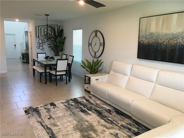 living room featuring a ceiling fan and tile patterned flooring