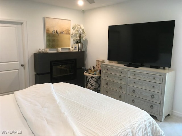 bedroom with a glass covered fireplace