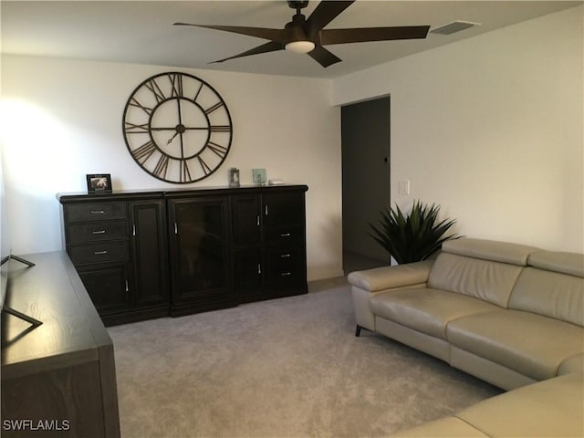 living room with light carpet, ceiling fan, and visible vents