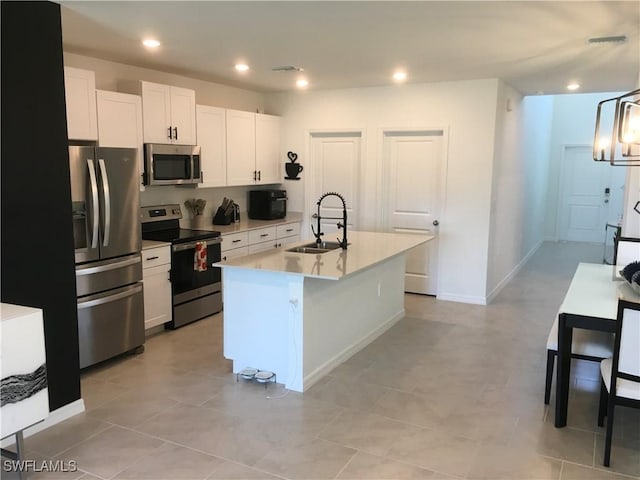 kitchen with recessed lighting, stainless steel appliances, a sink, white cabinetry, and light countertops